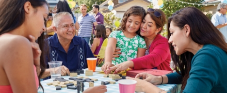 a group of people playing dominos