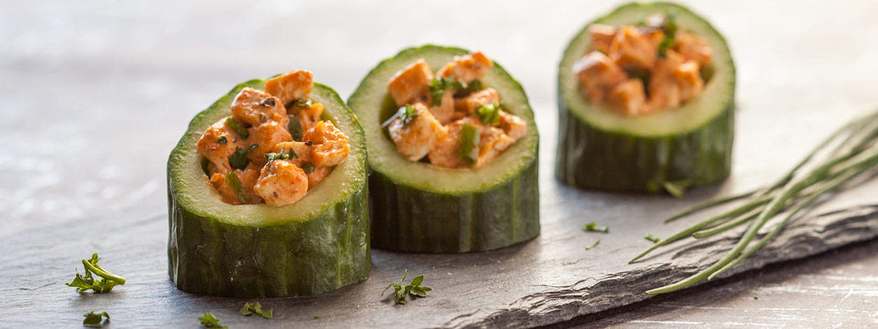 Multiple buffalo chicken salad stuffed cucumber cups